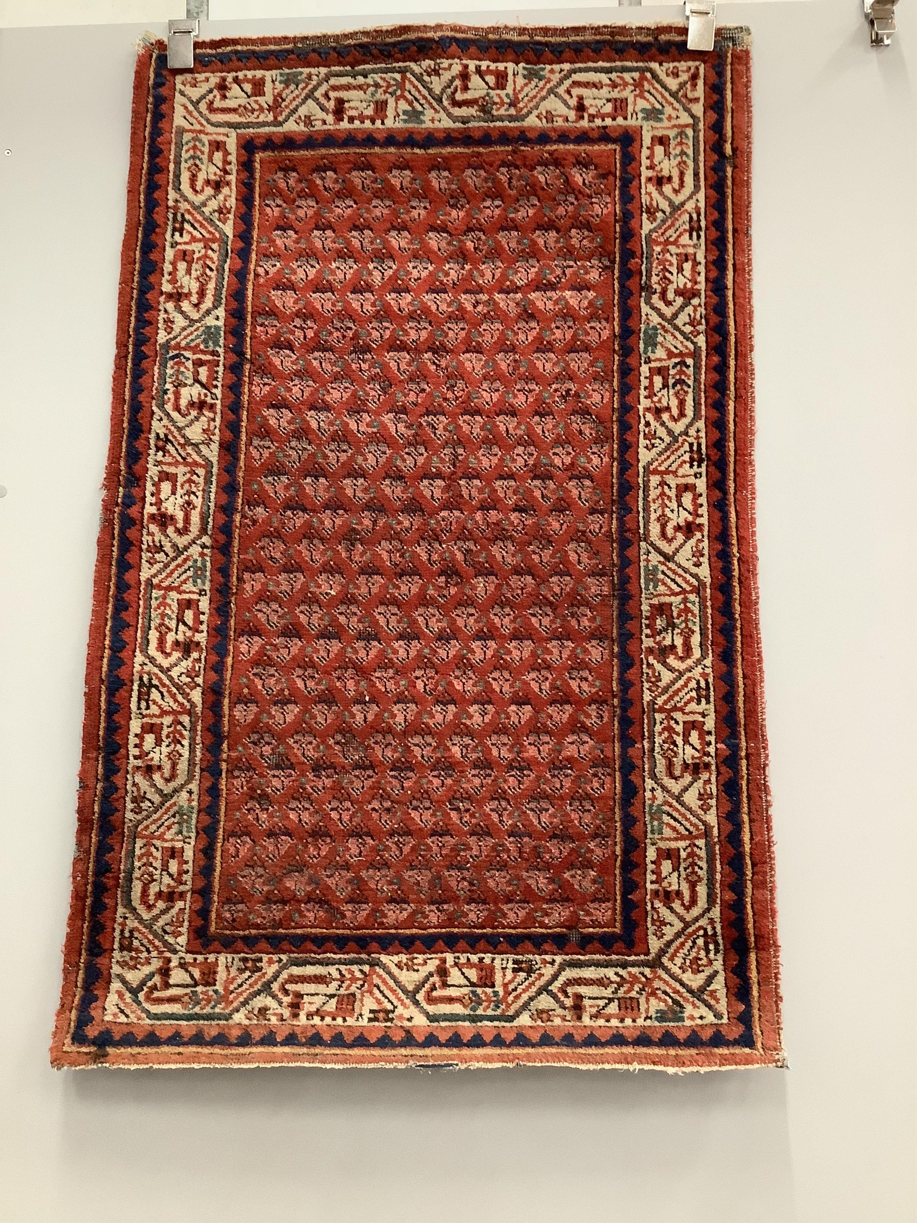 A pair of North West Persian brick red ground rugs, each 124 x 79cm. Condition - fair